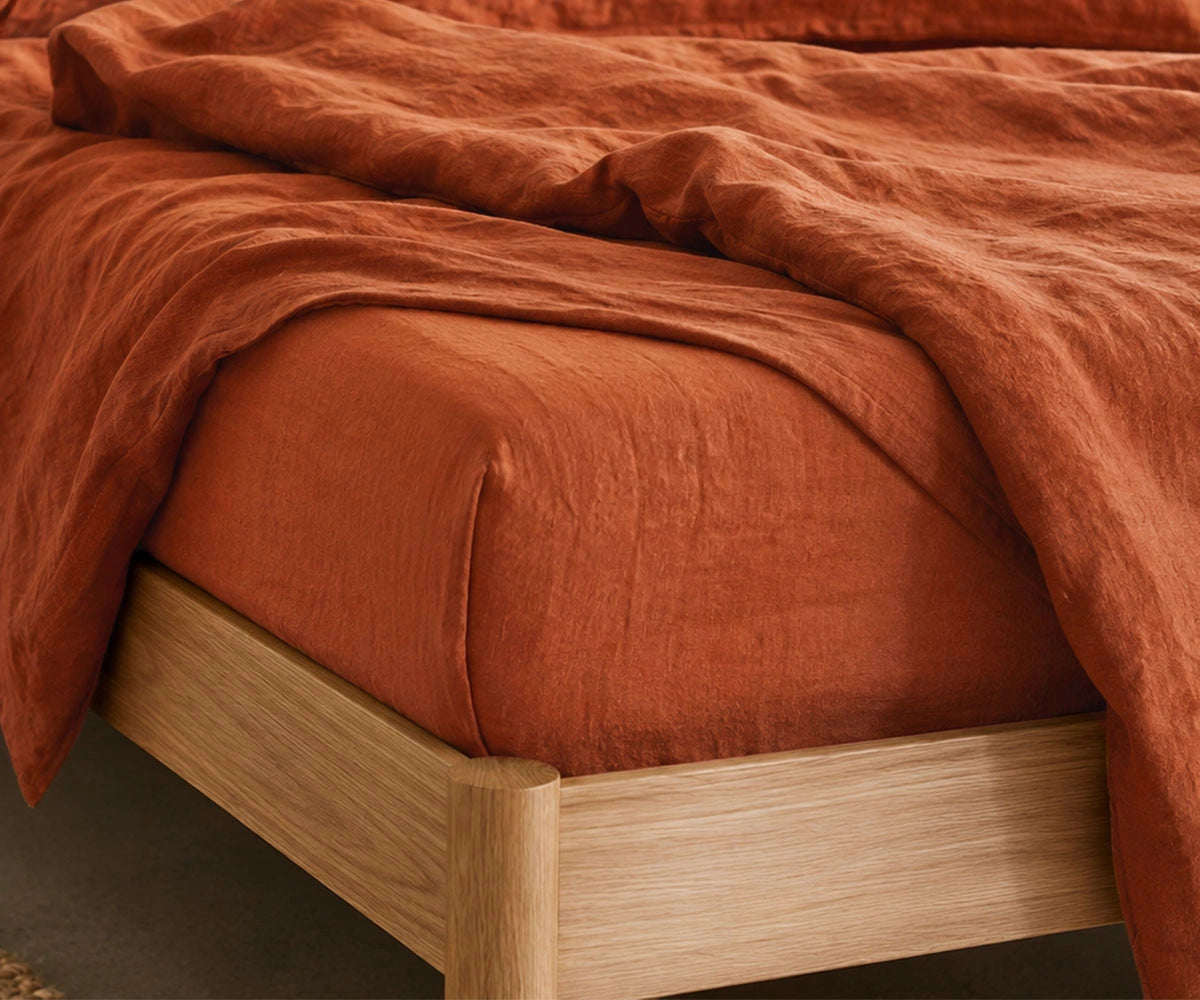 Terracotta bed sheets in soft breathable linen fabric, luxury rust orange bedding set with deep pocket fitted sheet for modern and farmhouse bedrooms