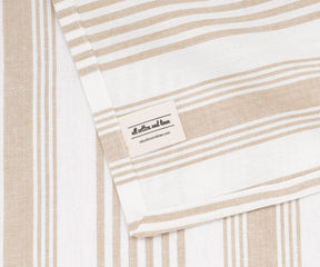 Beige striped cotton napkins with Our Brand Logo