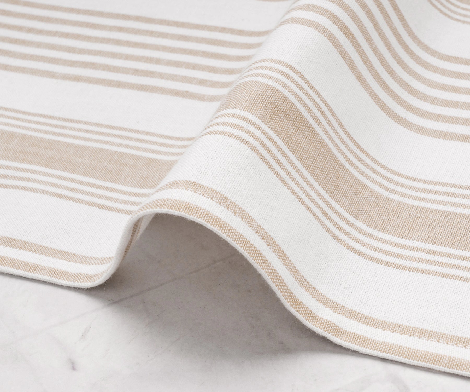 Close-up of beige striped cotton cloth napkin