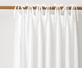 White natural linen tie top curtains, airy light filtering window panels for Scandinavian, coastal, and minimalist home interiors.