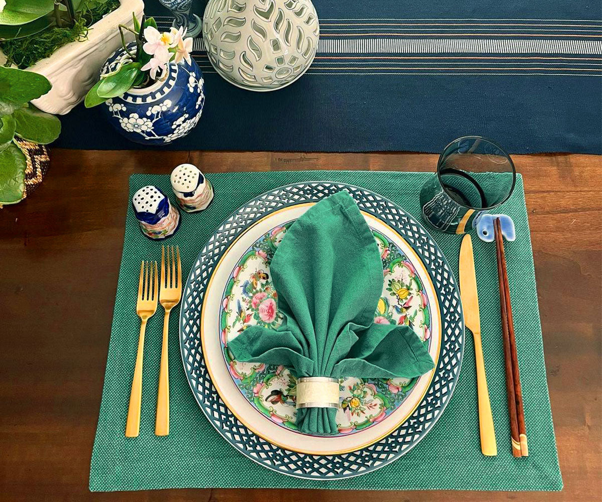 Upgrade your dining table with green fabric placemats, combining charm and protection for a delightful and stylish eating experience.
