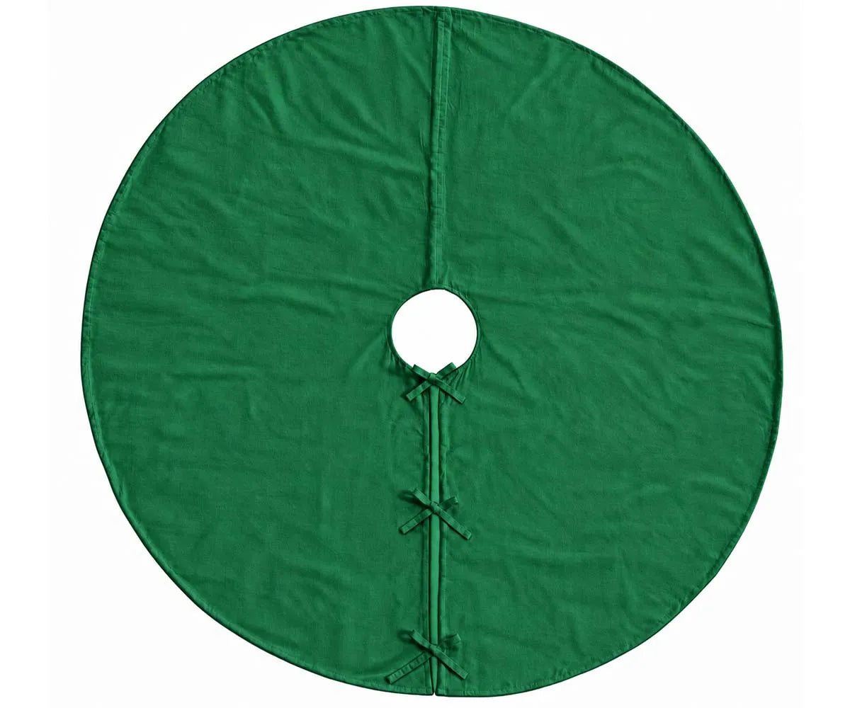 Plain green linen tree skirt arranged around the base of a Christmas tree for holiday decorating