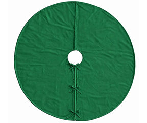 Plain green linen tree skirt arranged around the base of a Christmas tree for holiday decorating