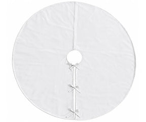 White linen tree skirt adding a simple finished backdrop around the base of a Christmas tree