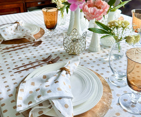 A round tablecloth is a fabric covering specifically designed to fit round tables. It is a circular piece of cloth that is used to cover the entire surface of the table.