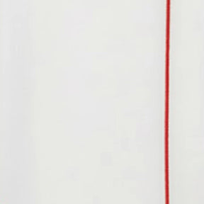 White cotton napkin featuring fine red embroidered accent along the edge, clean modern table linen design