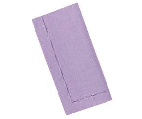 Elegant purple hemstitch linen napkins neatly folded on a dining table, showcasing their soft texture and refined design.