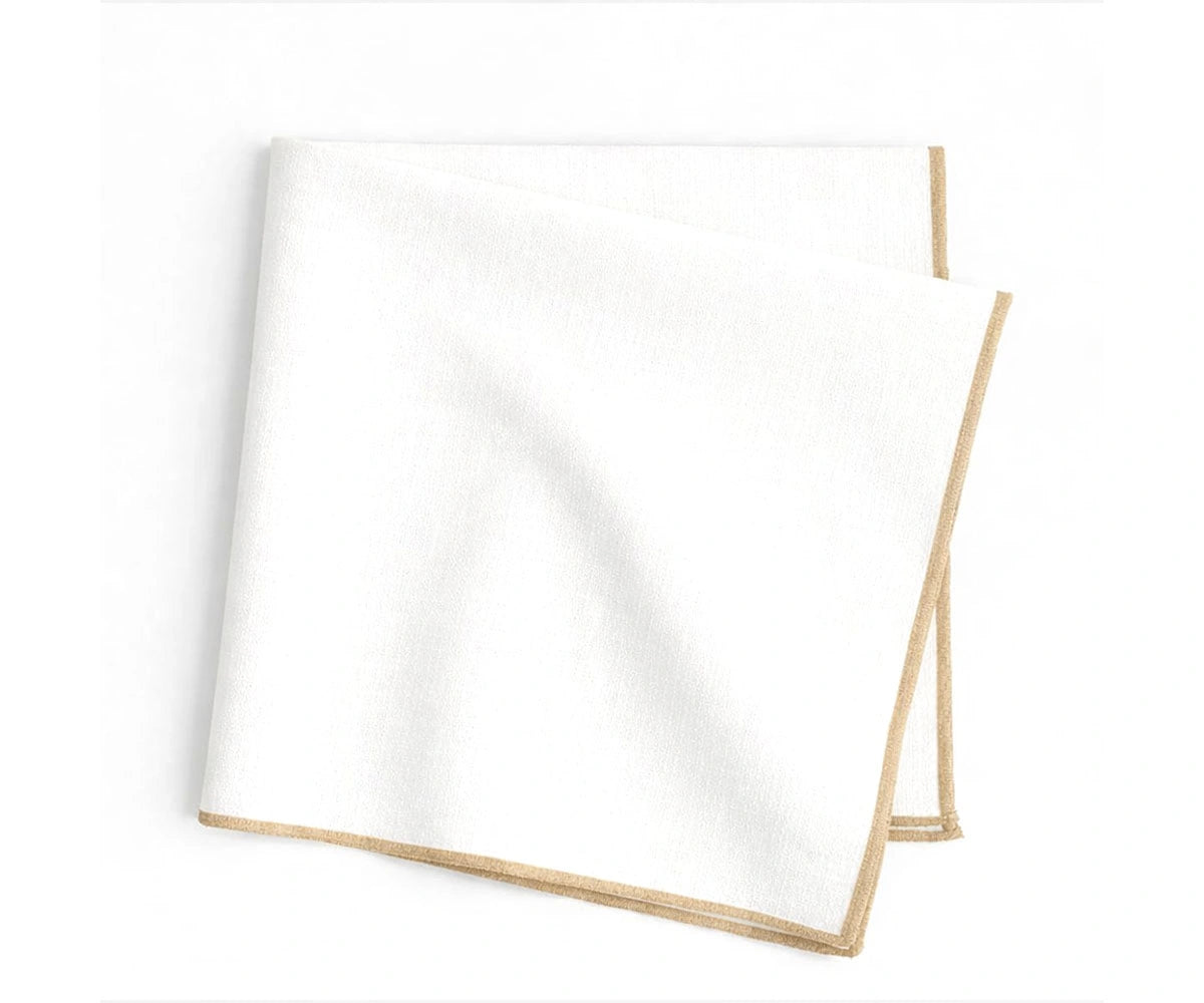 Soft white base cotton napkins finished with beige merrow stitched edges for everyday dining tables