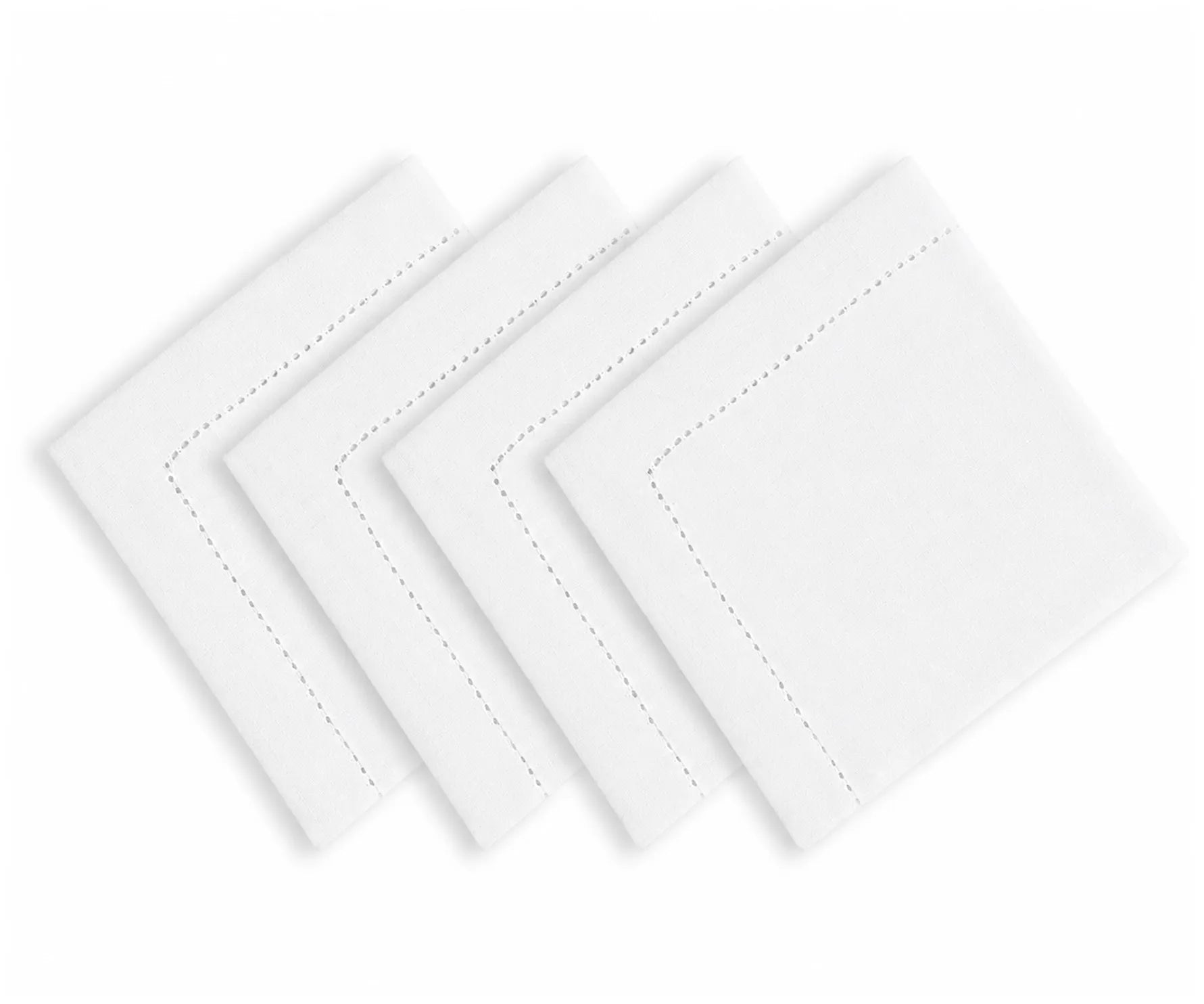 White hemstitched cotton linen blend dinner napkins arranged on an elegant dining table with classic dinnerware and neutral tablecloth