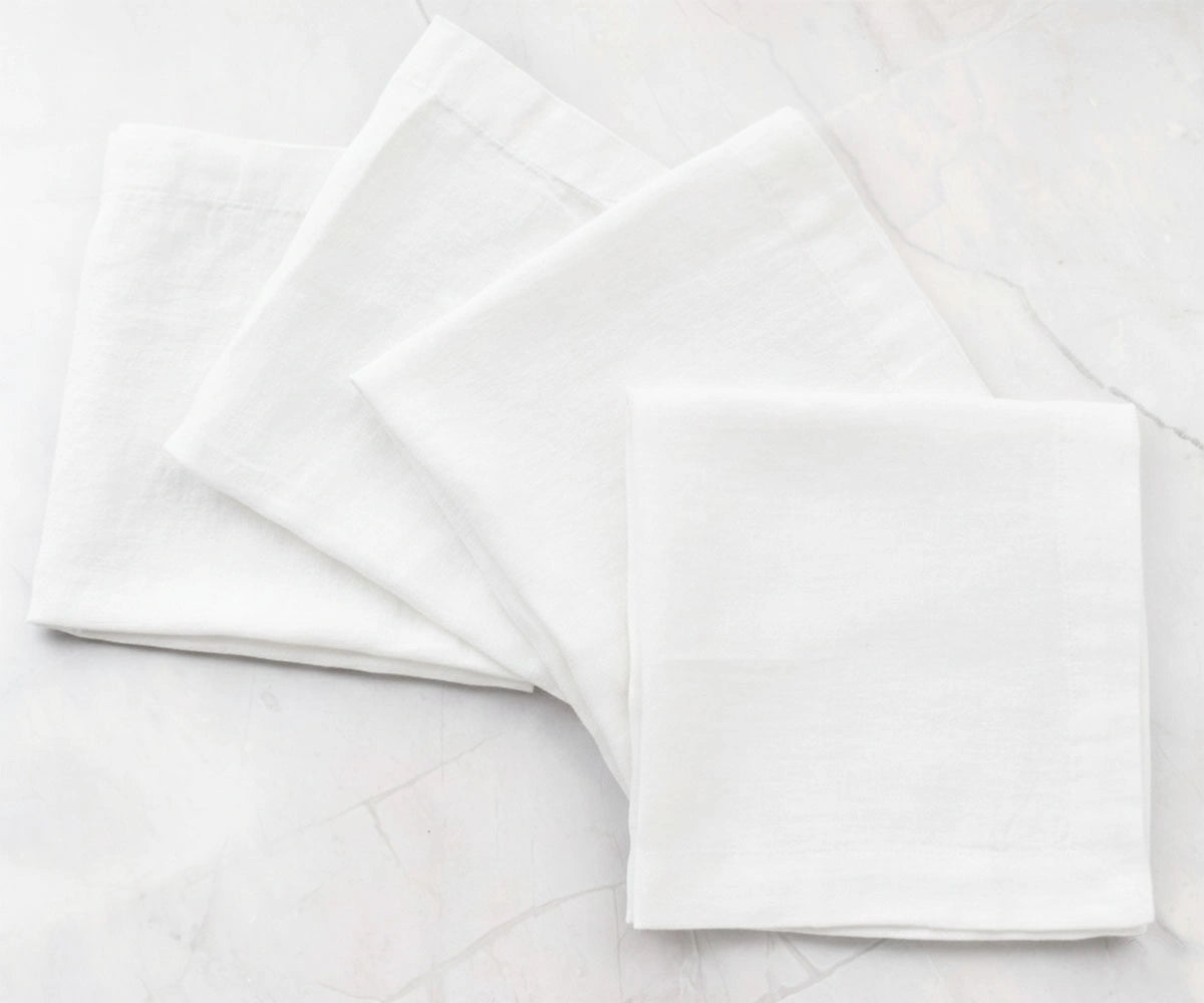 White solid cotton linen napkins styled on dining table, reusable fabric napkins