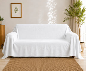 White cotton linen sofa cover with a clean solid finish, ideal for updating couches while helping protect against everyday wear. Washable couch cover and furniture protector .