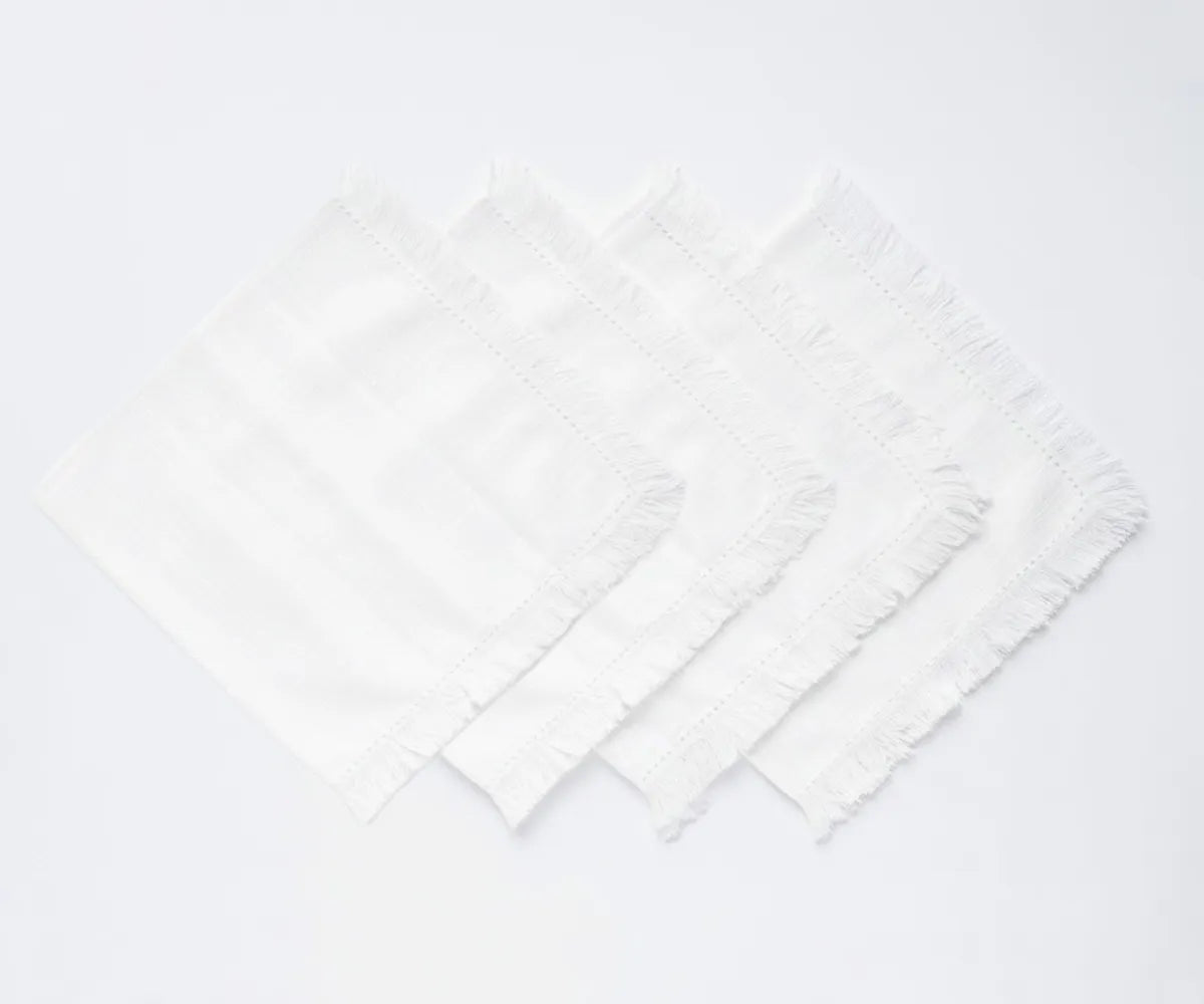 Textured cotton cloth napkins with fringe edge finish, perfect for layered table styling and coordinated table settings.