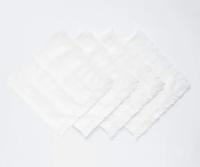 Textured cotton cloth napkins with fringe edge finish, perfect for layered table styling and coordinated table settings.