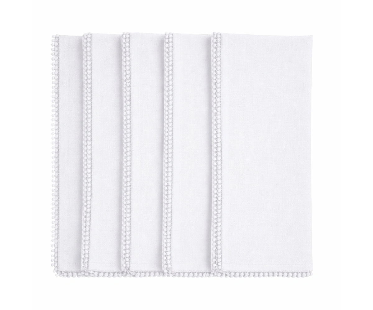 White cotton pom pom napkins with knotted edge for classic, wedding, and minimalist tables