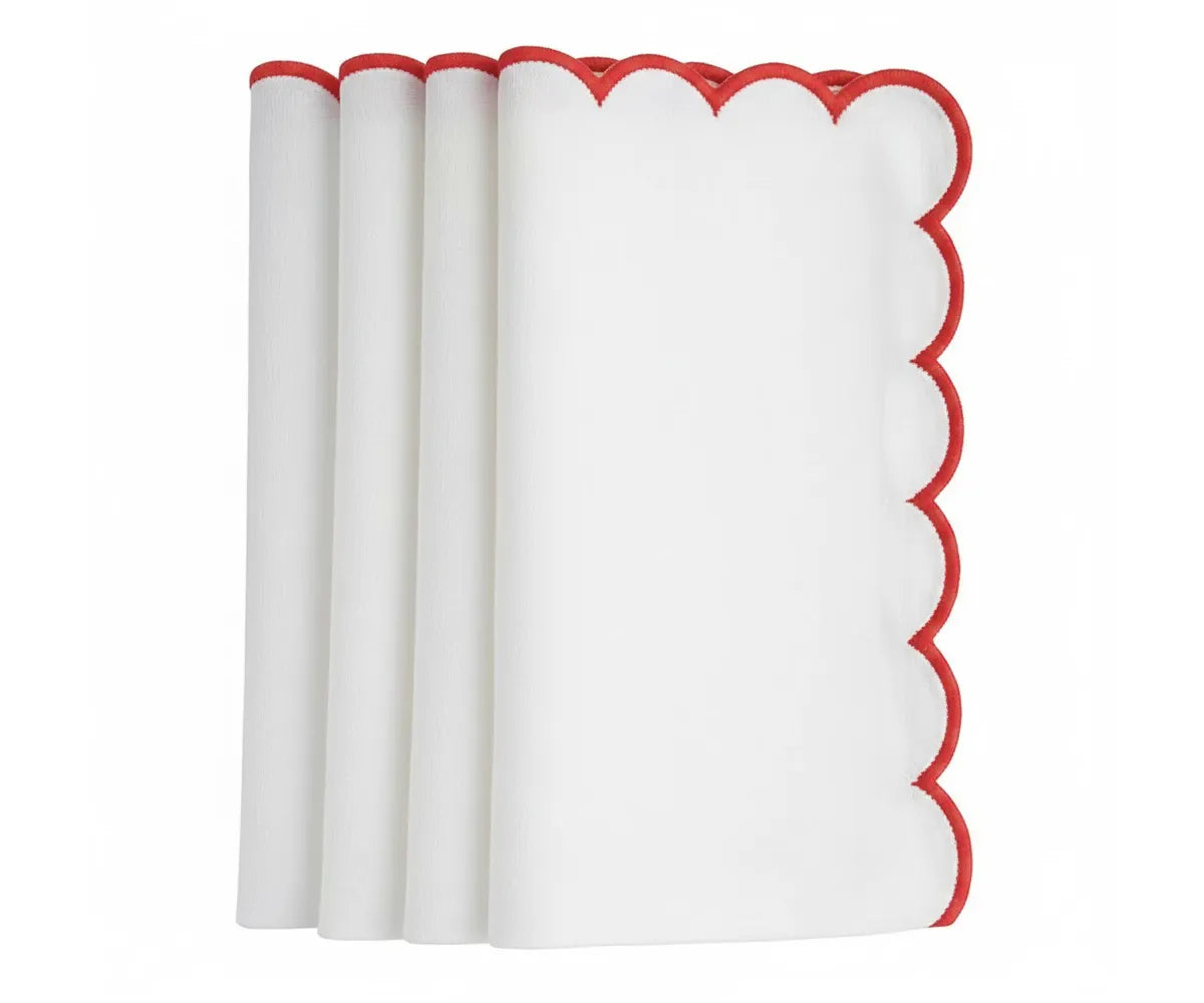 Scalloped cloth napkins with elegant red trim for dining tables