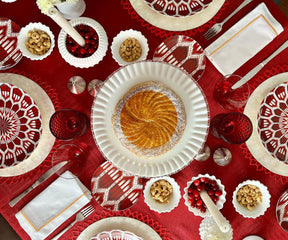 Holiday table setting featuring white dinner napkins
