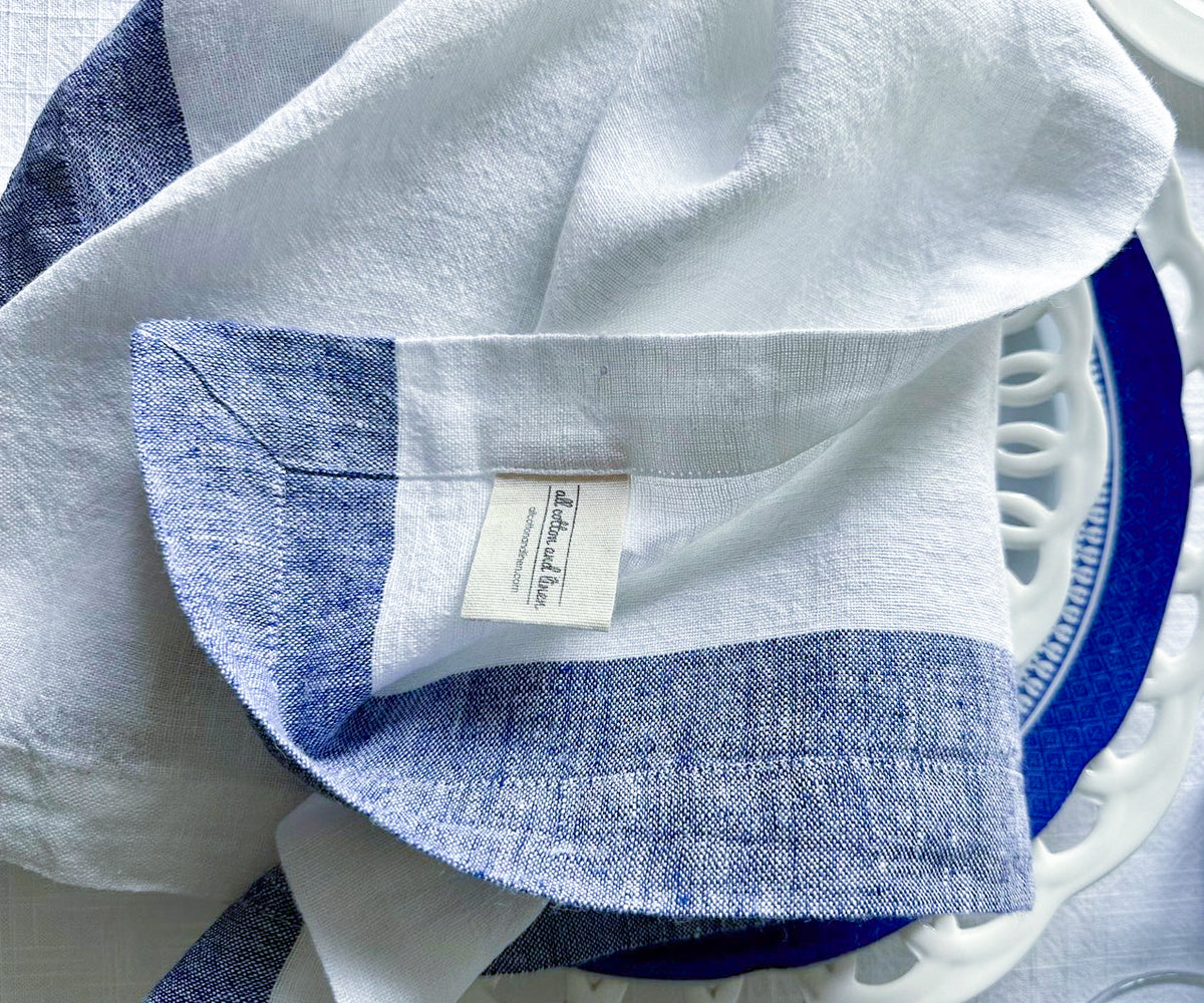 Blue and white linen napkins carefully arranged in a decorative basket