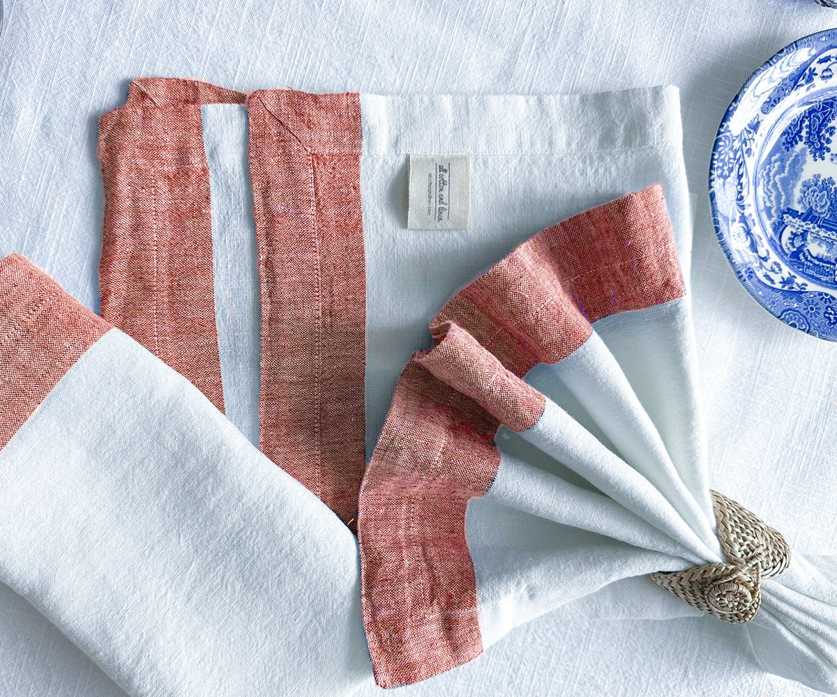 Crisp white linen napkin contrasted on a dark wooden table