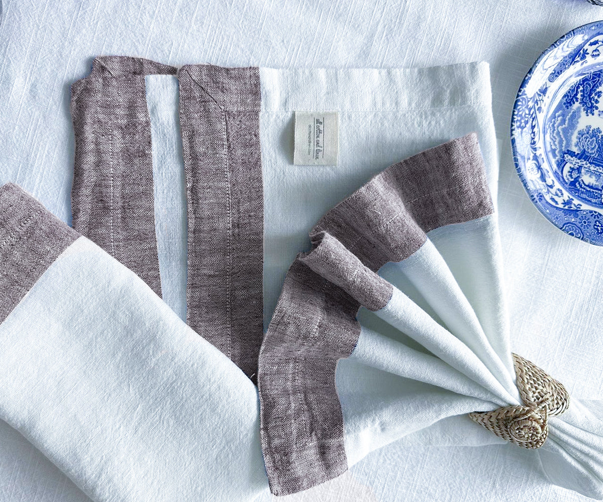 Stack of white linen dinner napkins folded neatly