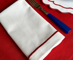 Collection of cloth table napkins in various colors and textures.