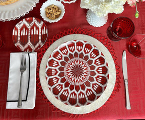 White cloth napkins on a red tablecloth