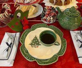 Black cloth napkins featured in a cozy Christmas table arrangement with a warm cup of tea