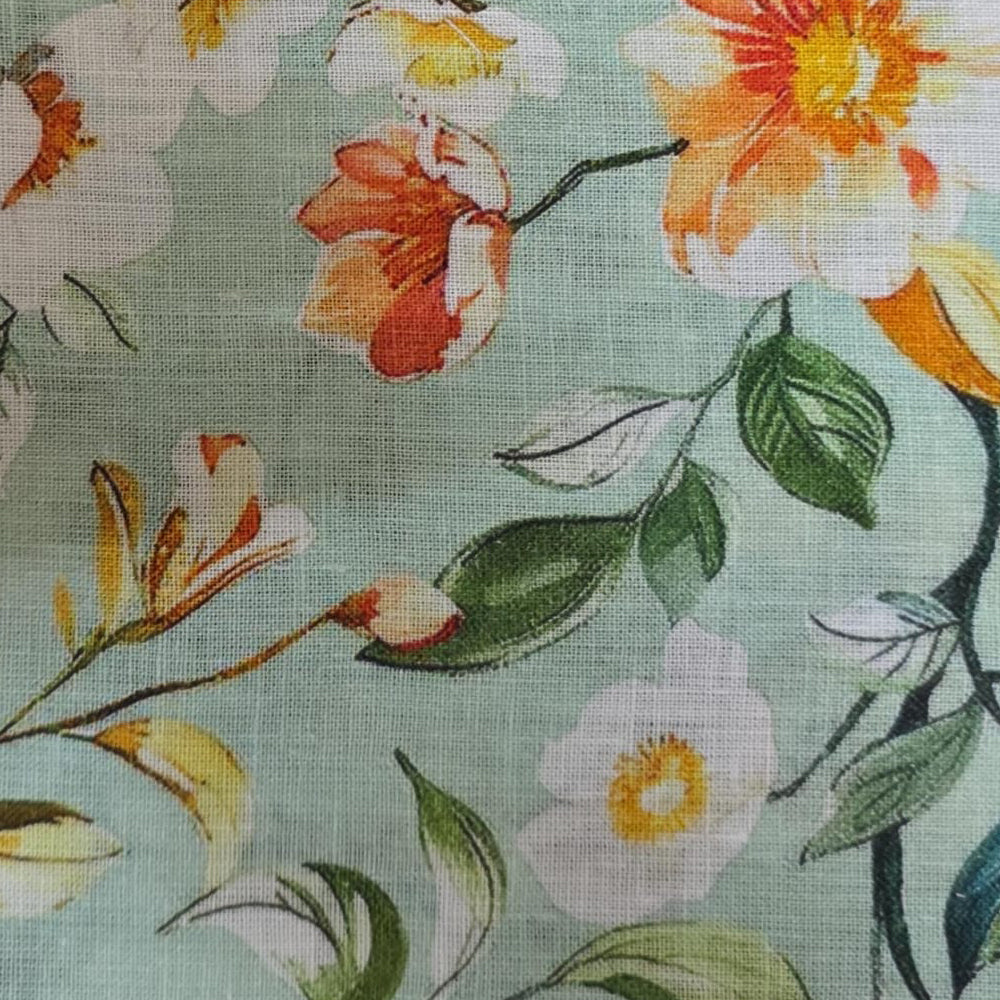 Round fabric tablecloth with decorative printed pattern displayed on a wooden pedestal table with soft draped edges.