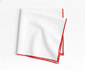 Classic white embroidered cotton napkins accented with bold red merrow stitching for elegant entertaining