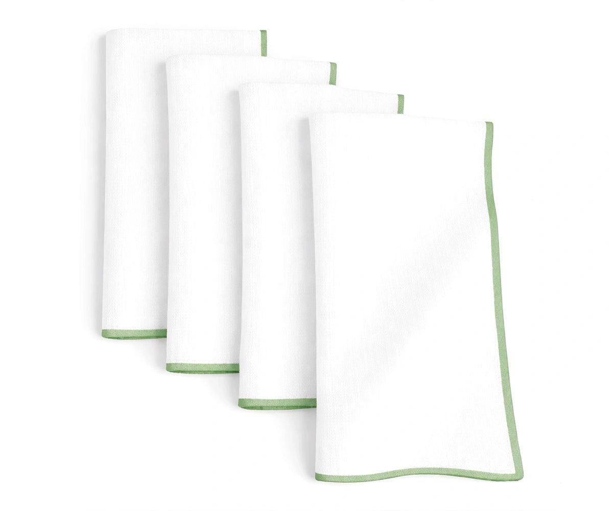 White base cotton napkins finished with sage green merrow stitching for calm and earthy dining décor