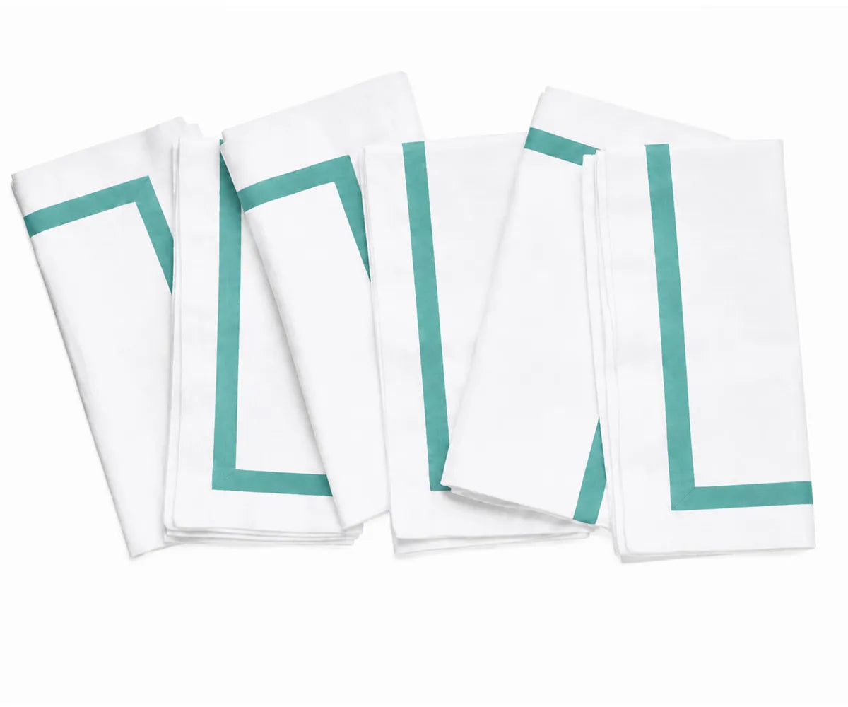 Soft and absorbent white dinner napkin with decorative trim, combining practical everyday use with timeless style.