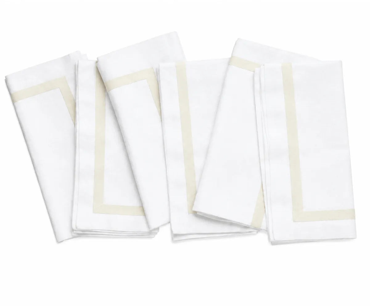 Reusable white cotton napkins arranged as part of a sophisticated dinner table setting for guests and family meals.