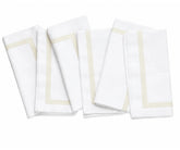 Reusable white cotton napkins arranged as part of a sophisticated dinner table setting for guests and family meals.