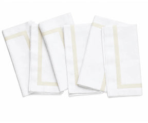Reusable white cotton napkins arranged as part of a sophisticated dinner table setting for guests and family meals.
