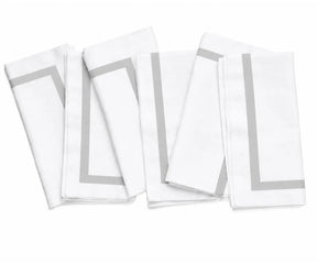 Decorative white cloth napkin with colorful edging, bringing subtle visual detail to an elegant dining arrangement.