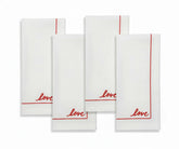 Set of white cotton cloth napkins with minimalist embroidered detail.