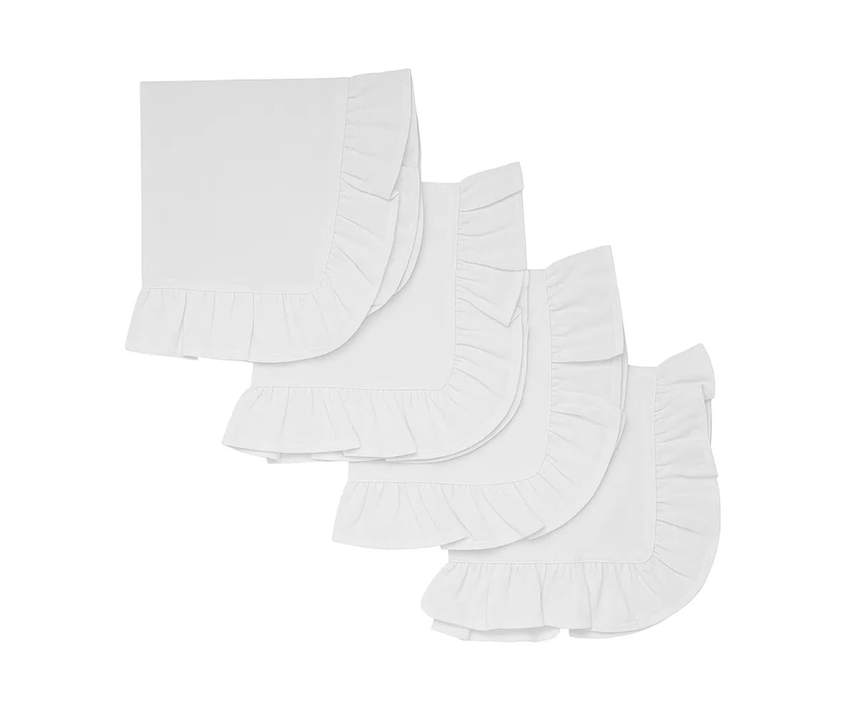 White cotton ruffle edge dinner napkins neatly folded on a table
