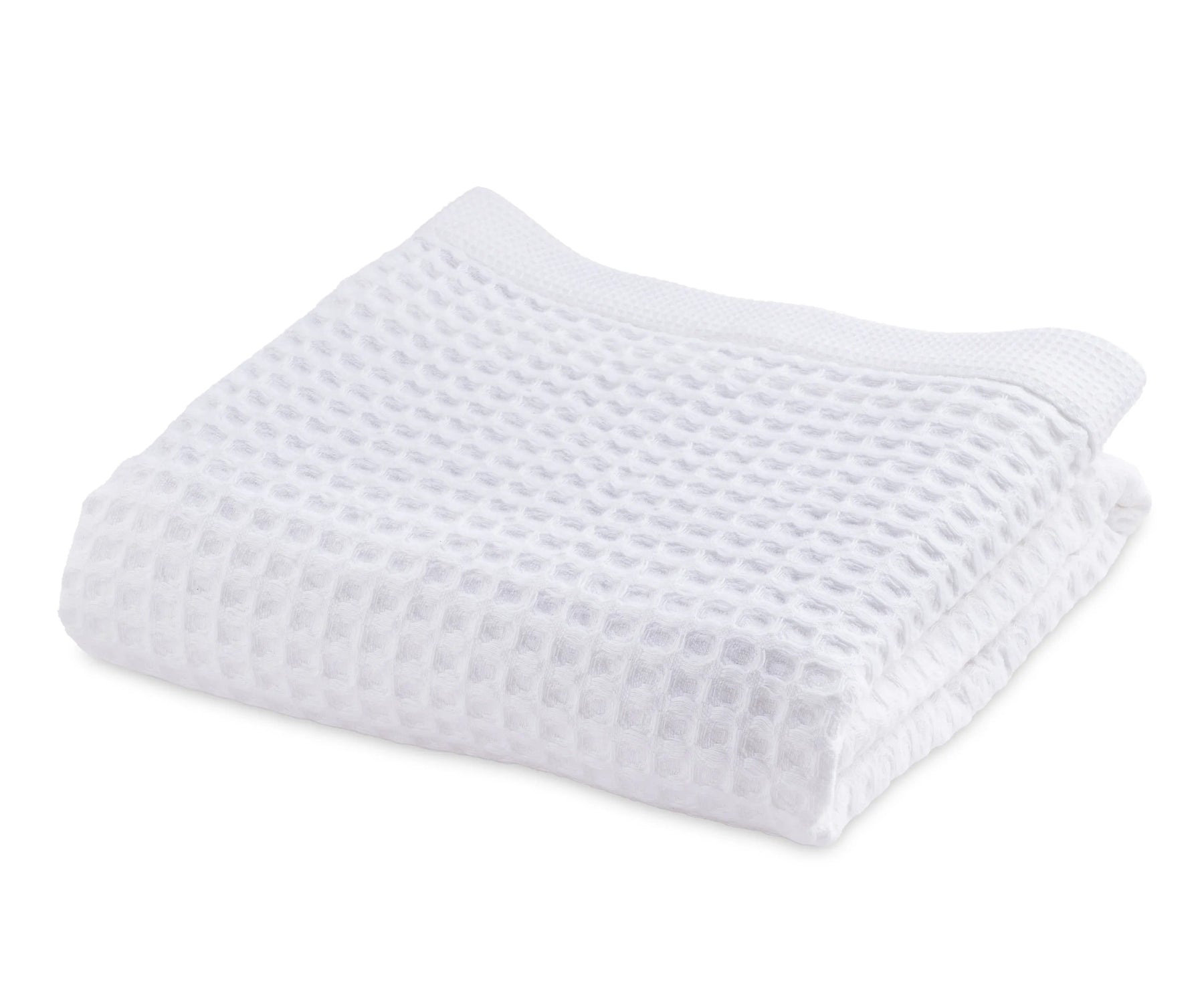 A high-resolution image showing a neatly folded white cotton waffle towel with a textured waffle weave pattern, highlighting its softness, absorbency, and thick quality. Ideal for home, spa, or gym use.