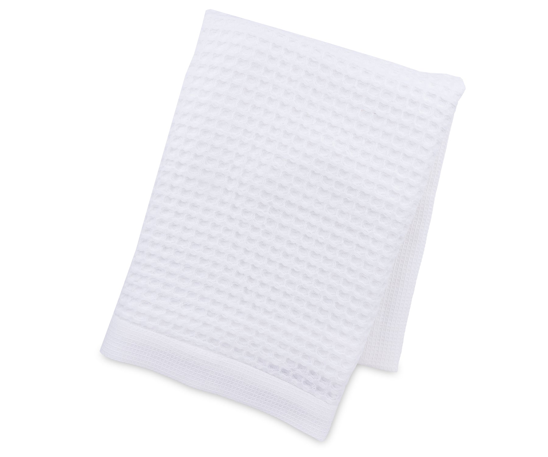 A styled bathroom scene featuring luxury white waffle towels draped beside a bathtub, emphasizing their plush texture, elegant look, and superior absorbency. Perfect for spa-like home settings