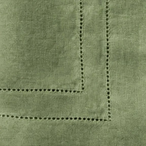 Close-up of Willow Green linen cloth napkins featuring premium 100% linen fabric and classic double hemstitch border for luxury table décor.
