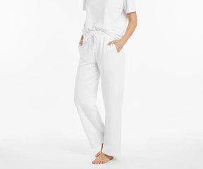Women’s loose-fit white cotton pants made with soft, breathable material for casual wear.