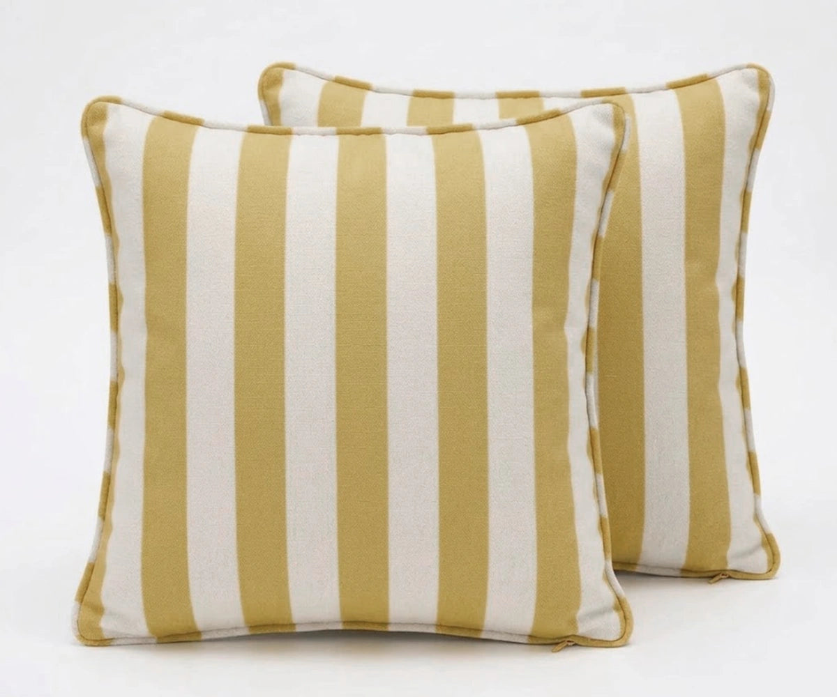 Two striped pillows with yellow and white stripes on a white background
