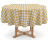 A round table covered with a yellow and white gingham checkered tablecloth, shown on a light wood pedestal against a plain white background.