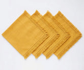 Elegant cotton table napkins with decorative fringe edges, designed for stylish place settings and dining decor.