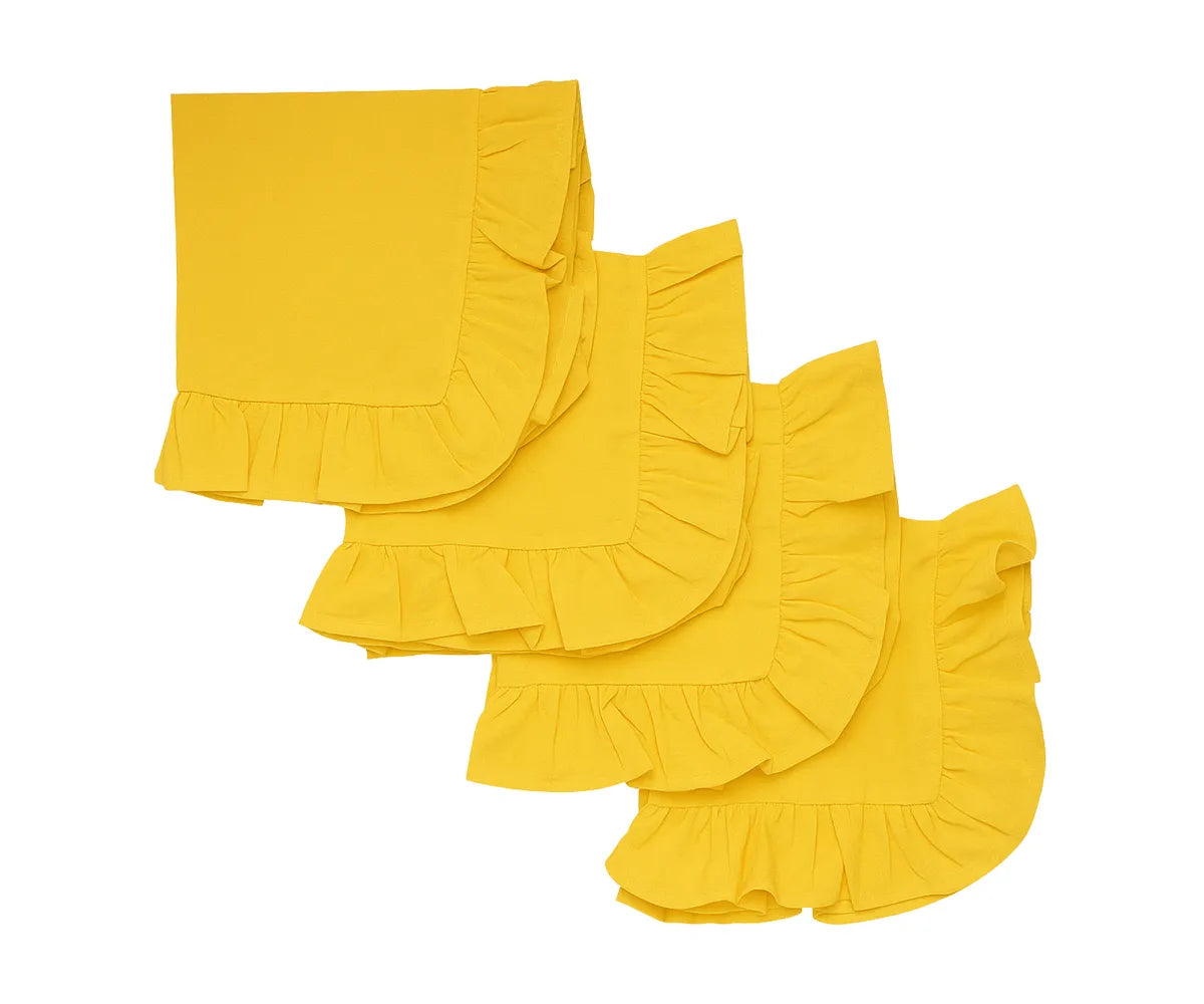 Yellow cotton ruffle edge dinner napkins set on a dining table