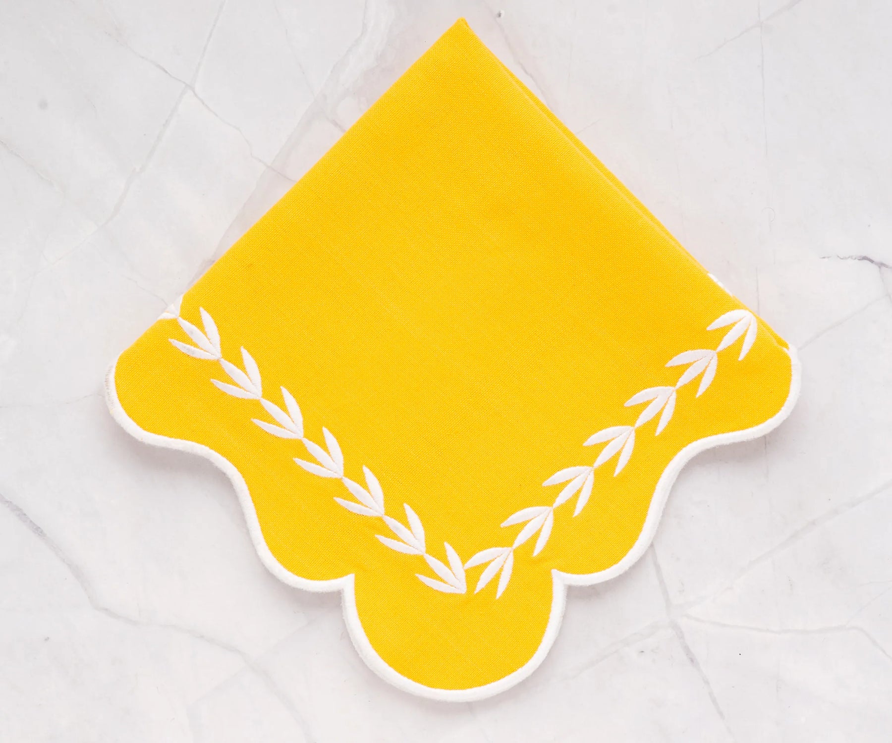 Yellow scalloped cotton napkins styled with a matching yellow tablecloth, bright and elegant napkins for family dining and entertaining