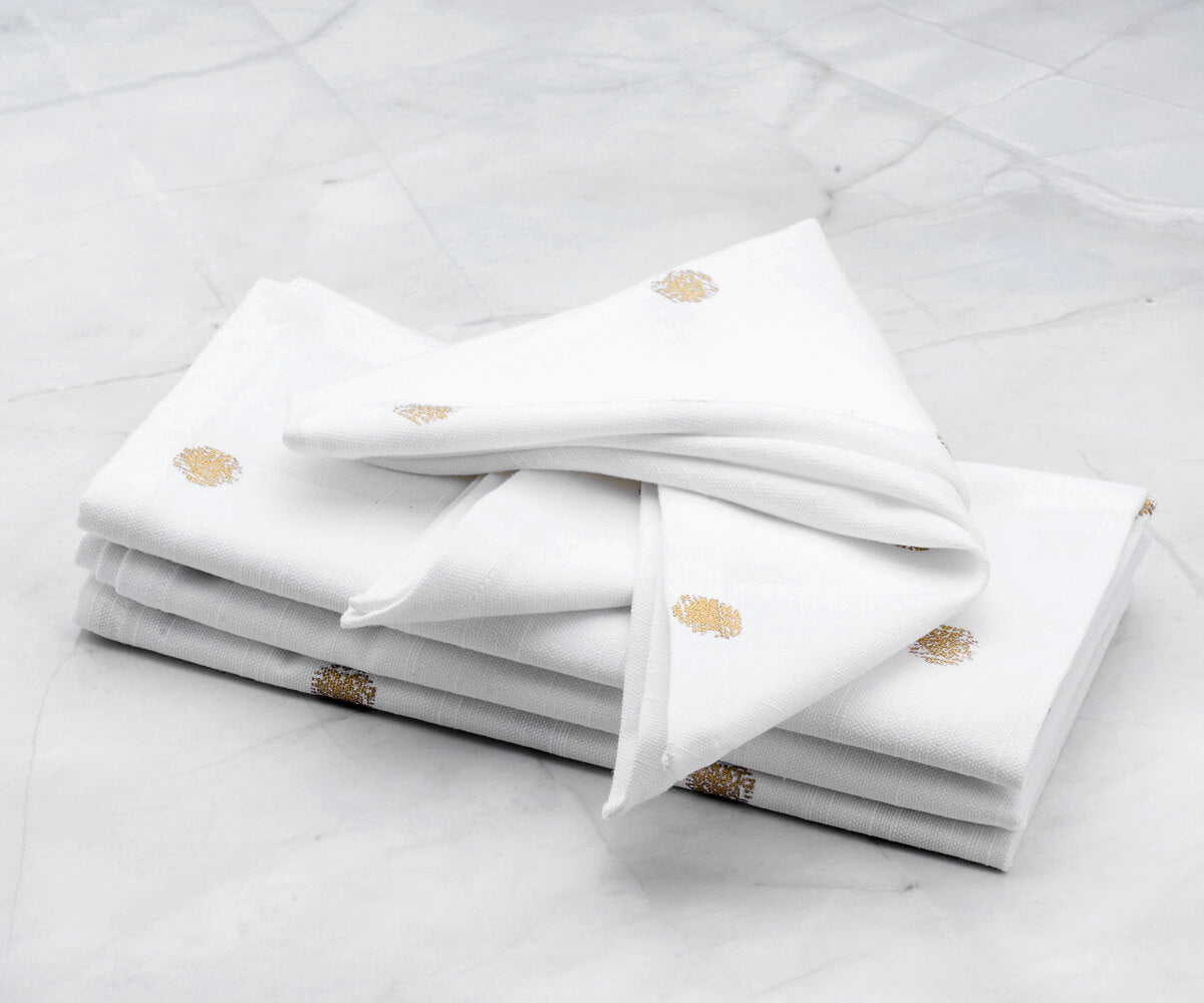 Set of 4 White napkins- Printed cocktail napkins  are arranged one above another.(Cloth Napkins Gold)
