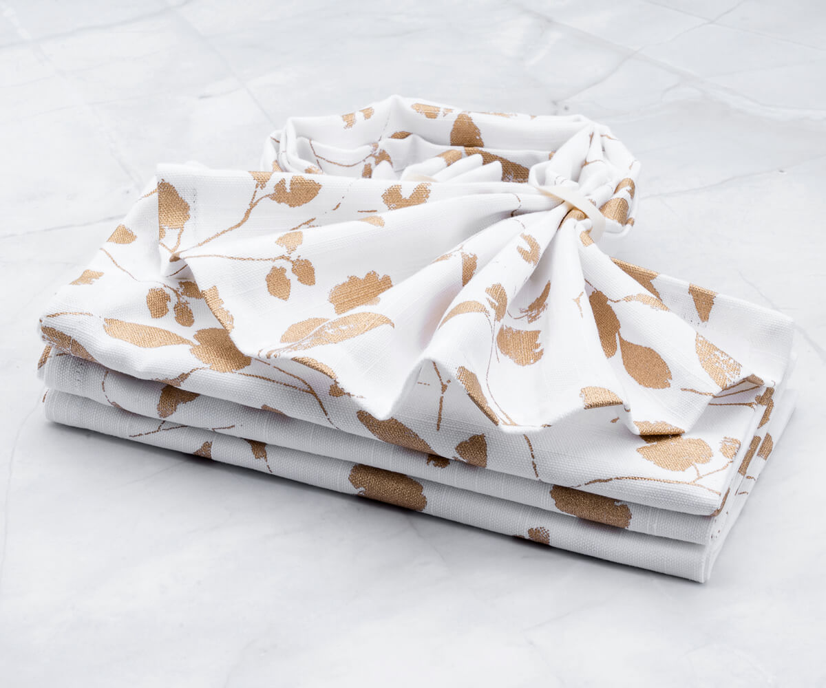 White napkins - metal printed napkins with copper prints (white and gold napkins) are arranged one above another features (Cloth Dinner Napkins)