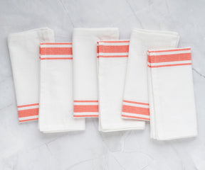 Set of 6 restaurant napkins with orange stripes displayed