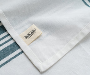 Blue and white striped bistro napkin with a label