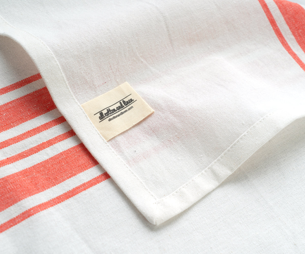 White restaurant napkin featuring red stripes